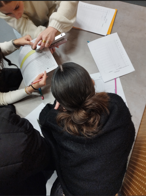 Des élèves perforent une feuille selon le programme qu’ils souhaitent exécuter.